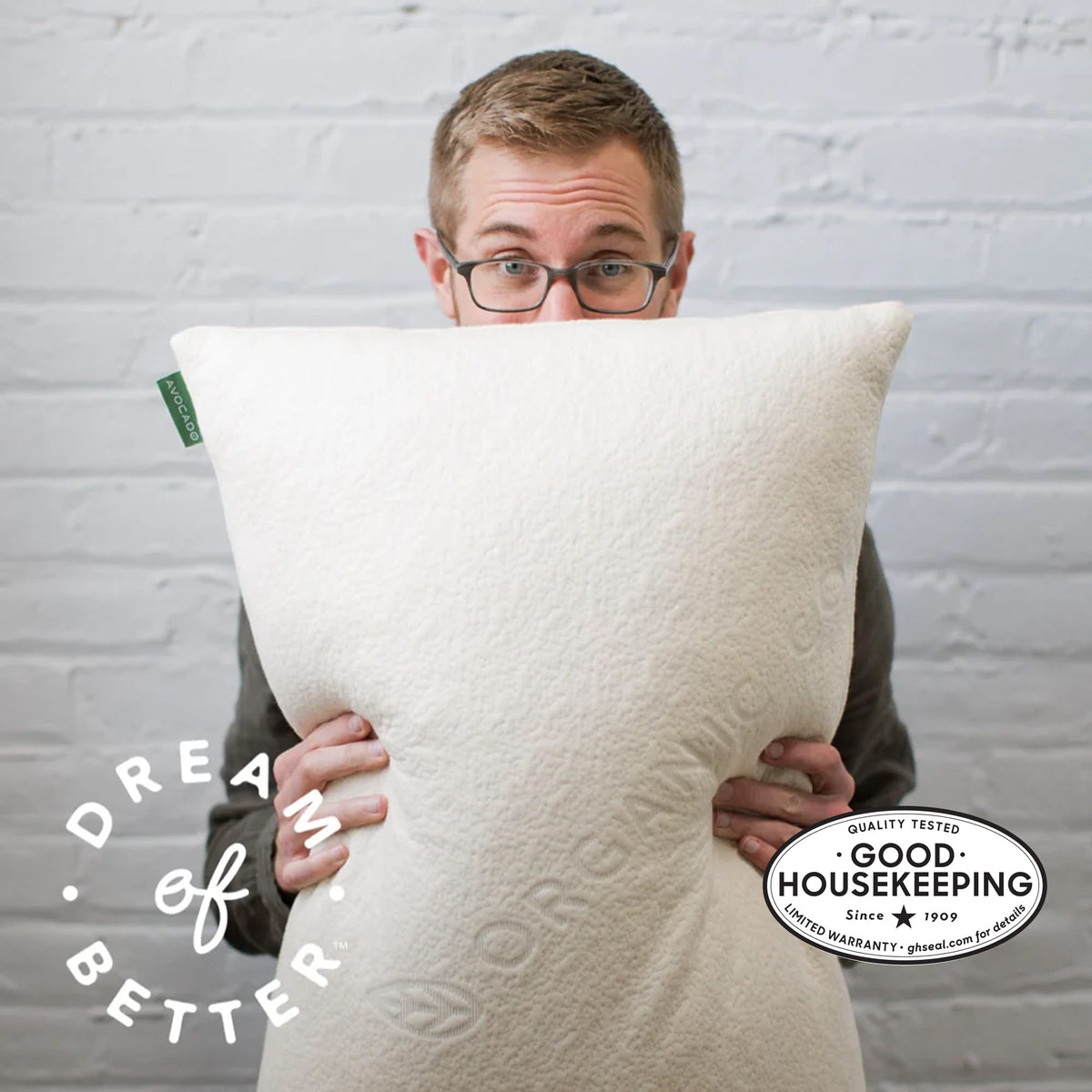 Man holding Avocado Green Pillow image shows Good Housekeeping Seal Main image