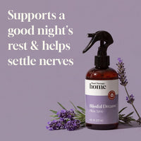 Bottle of Plant Therapy Blissful Dreams Pillow Spray with lavender flowers on a purple background
