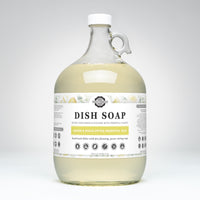 Large glass bottle of dish soap with a label on a white background