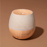 Wooden diffuser with beige fabric cover on a brown background