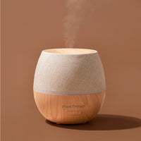 Wooden diffuser with beige top on a brown background