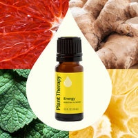 Essential oil bottle labeled 'Plant Therapy Energy' surrounded by natural elements like a grapefruit, ginger root, and lemon.