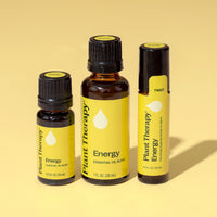 Three Plant Therapy Energy essential oil bottles on a yellow background