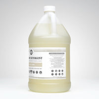 Gallon bottle of fabric detergent on a white background