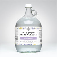 Glass bottle of spray cleaner with a label on a white background
