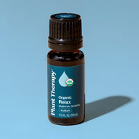 Bottle of Plant Therapy Organic Relax essential oil blend on a blue background