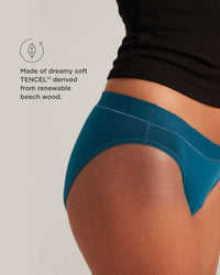 Teal underwear worn by a person on a light gray background with TENCEL branding.