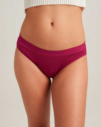 Maroon underwear worn by a person on a plain background