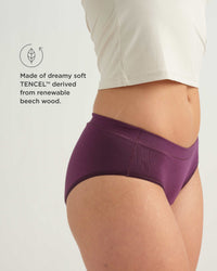 Purple underwear worn by a person on a white background with TENCEL™ label.