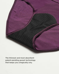 Close-up of purple fabric with black gusset technology on a light gray background
