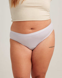 Person wearing light gray underwear on a plain background