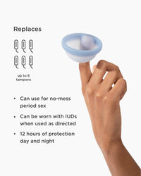 Hand holding a menstrual cup with features listed on a white background