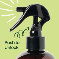 Black spray bottle with 'Push to Unlock' text on a green background