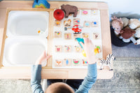 Child playing with educational toys at a wooden table