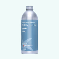 A silver aluminum bottle of Plaine Products refill/reuse body wash with a light blue label, reading 'BODY WASH' and 'Rosemary Mint Vanilla,' on a very light blue background.