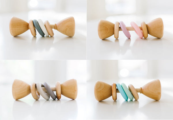 Four views of a wooden baby teething toy with colorful rings, displayed on a clean white background.