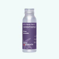 Silver bottle of conditioner with purple label on a white background