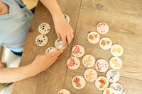 Children playing with animal-themed cookies on a wooden table