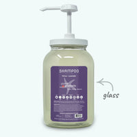 Glass shampoo bottle with pump and purple label on a white background