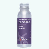 Shampoo bottle with purple label and silver cap on a white background