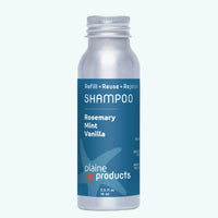 Plaine Products shampoo bottle with blue label on a white background