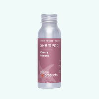 Shampoo bottle labeled 'Cherry Almond' by plaine products on a white background